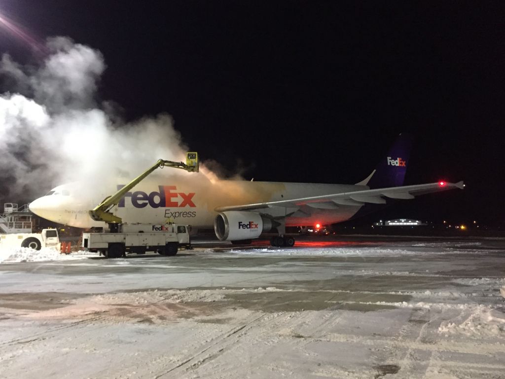 Airbus A300F4-600 (N671FE) - Treating the Airbus fuselage with Type 1 Deicer (propylene glycol & very hot water) on a 5 F January evening in the Upper Midwest.  .