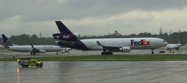 Boeing MD-11 (N581FE) - FedEx MD-11 waiting for Rwy 15L as HFD AR15 rolls by