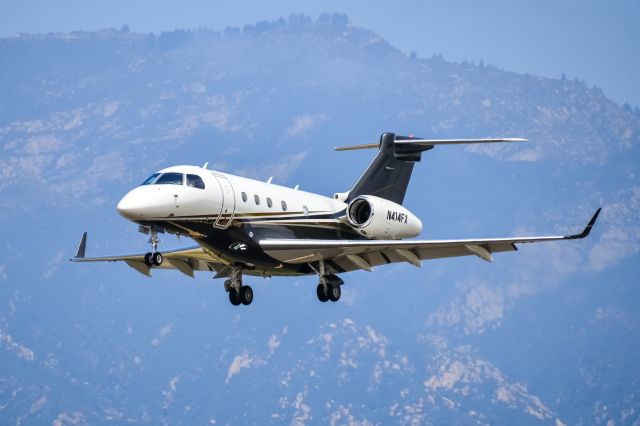 Embraer Legacy 450 (N414FX) - N414FX approaching with some nice mountains in the background.