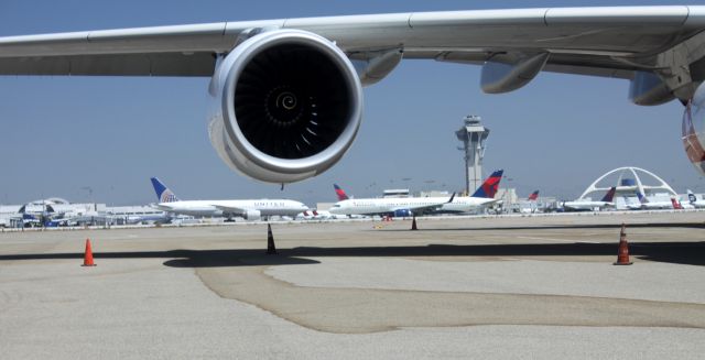 Airbus A380-800 (VH-OQH) - Wing of "Reginald Ansett" A380 frames KLAX showing UA, DL, FAA Tower and Encounter Restaurant ( "Space Ship") in between flights of 08-08 and 08-09 2012