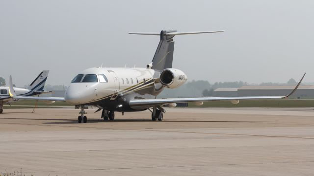 Embraer Legacy 450 (N434FX) - A Flexjet E545 begins to taxi away from the FBO at La Porte Municiple Airport with the haze in the background.