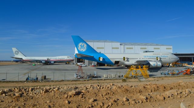 Boeing 747-200 — - Two 747s owned by General Electric with the specific duty to test GE engines used on aircraft. GE has a test facility at Southern California Logistics Airport (KVCV). The 747 in the background was painted to the newer colors of the 747 in the front. I was privileged to see them both in different schemes at the same time. 