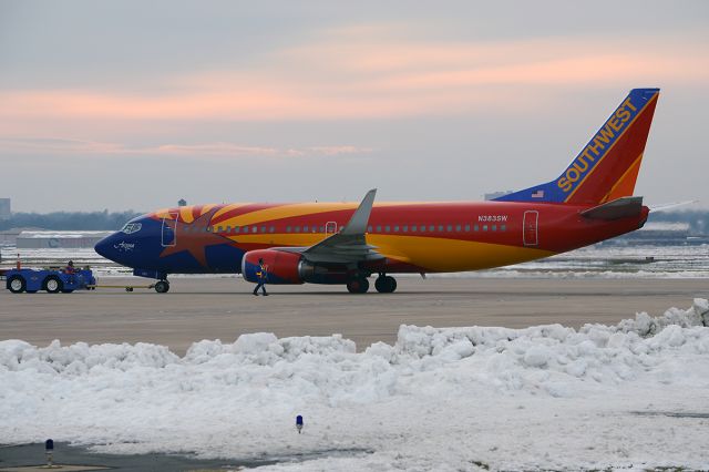 BOEING 737-300 (N383SW) - Pushback. December of 2012, post Christmas snow. With my friend GulfstreamGuy spotting the wing