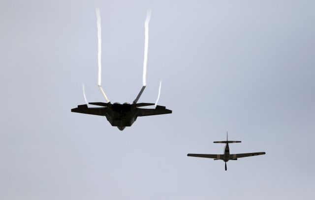— — - Pilot Kevin Eldridge in a P-51 Mustang and an F-22 Raptor fighter jet piloted by Major John Cummings perform a U.S. Air Force Heritage Flight at the California International Airshow in Salinas, California, September 27, 2015. (Photo by Michael Fiala/Reuters)