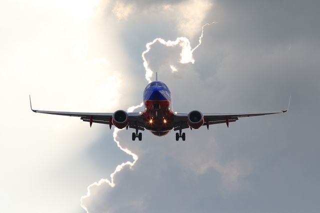 Boeing 737-700 — - An approaching storm created a cool background. Questions about this photo can be sent to Info@FlewShots.com