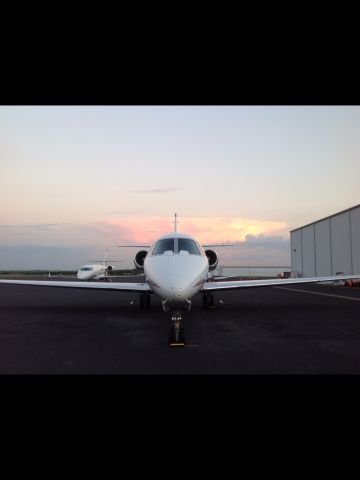 — — - Ramp at sunset, Signature FBO Austin