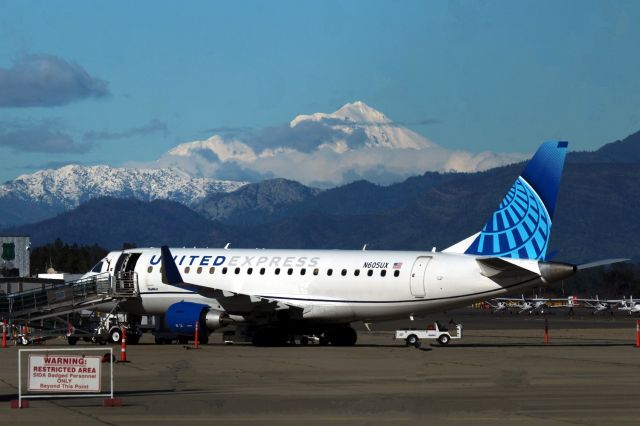 Embraer 175 (N605UX) - RDD/KRDD - Feb 6 2024 Mt Shasta looms in the 50 mile distance as fresh snow from winter storms has topped the mountain nicely/ Newer colors United Loading for LAX. Redding  is pretty much all E175s now except for the occasional RJ200, Alaska Skywest is all E-175 and Avelo Airlines still on hiatus, with no flights until April 2024. My 1st flight on a United E175 was Jan 19 2024 and I do not like that jet. Both flights RDD-LAX, then final SFO-RDD were is heavy storm clouds and heavy turbulence the entire way.. I could not see anything, but the window bulkheads didnt help either being off set. The landing by the Pilots in heavy winds and rain Jan 20th was like landing with no tires on the gear, though excellent work by the Pilots, they really had to stick it on Runway 16..very hard landing and a full flight.