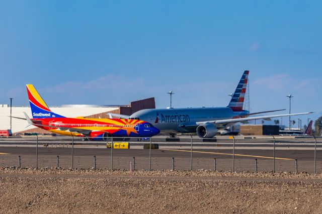 Boeing 737-700 (N955WN) - Southwest Airlines 737-700 in Arizona One special livery taxiing in front of an American Airlines 777-200 at PHX on 11/13/22. Taken on a Canon R7 and Tamron 70-200 G2 lens.
