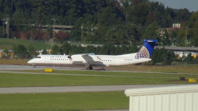 de Havilland Dash 8-400 (N341NG) - Turning onto runway 23R.