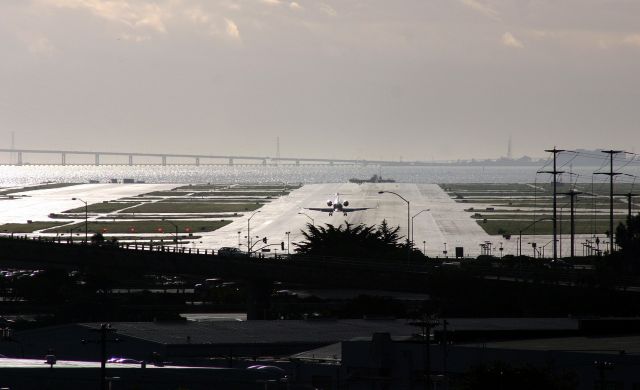 — — - KSFO - View of runway 10L at KSFO from the San Bruno BART parking garage. View looking SSE.