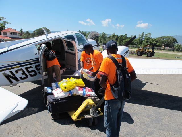 Beechcraft Baron (58) (N359P) - Unloading medical supplies in Jacmel, Haiti in Jan, 2010.