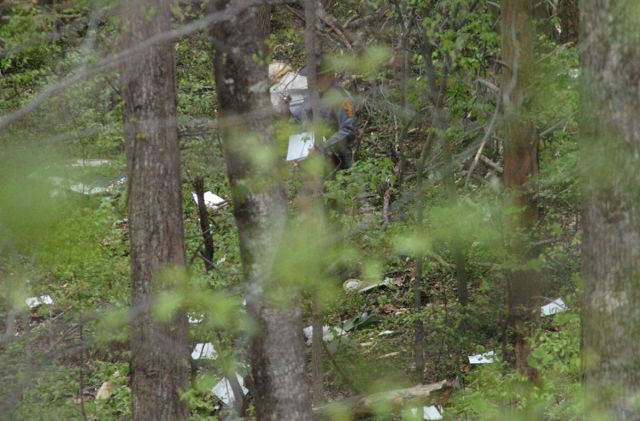 N4535N — - Virginia State Trooper walks through the crash site of this Gruman American AA-5B which crashed near the Danville Regional Airport in Danville Virginia 4/19/07..NTSB NYC07LA098....2 Fatal.