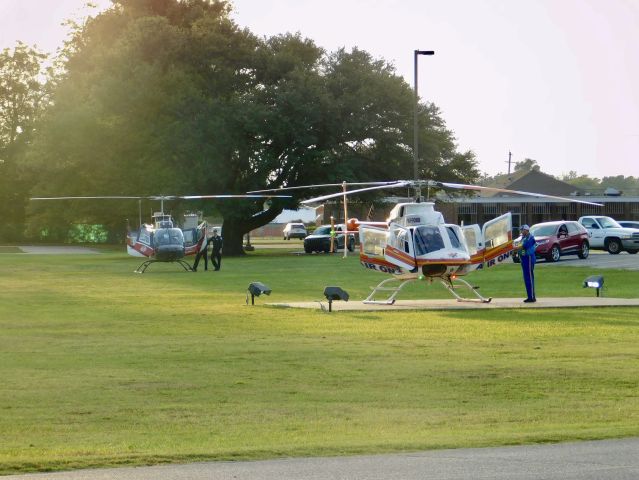 Bell JetRanger (N539AE) - Air Evac 87 in the grass at Bolivar Medical Center waiting for Pafford Air One Echo to leave
