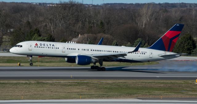 Boeing 757-200 (N6714Q) - (3/8/2017) Nice touchdown from our daily 757, captured from the north side of the parking deck, runway 28R