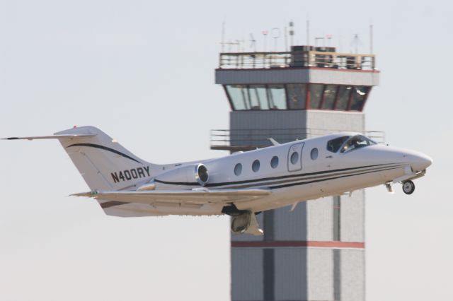 Beechcraft Beechjet (N400RY) - Robert Yates racings BeechJet heads home after some freshening up at Stevens Aviation. departs past the fairly new tower at KGYH.