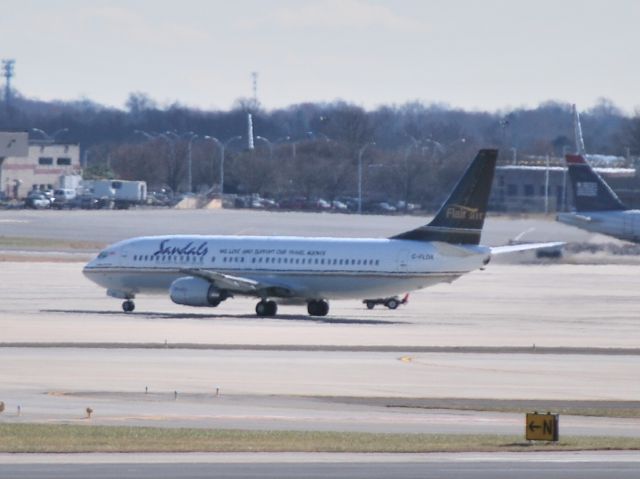 BOEING 737-400 (C-FLDX) - Waiting on the ramp for a gate to open. Not a great photo, but an unusual visitor. - 12/10/14 