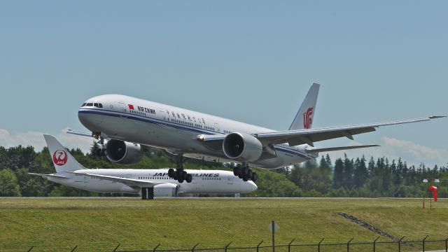 BOEING 777-300 (B-2039) - BOE164 on final to runway 34L to complete a flight test on 6/28/13. (LN:1114 cn 38679). Behind on the taxiway is BOE186 (JA832J) waiting to depart.