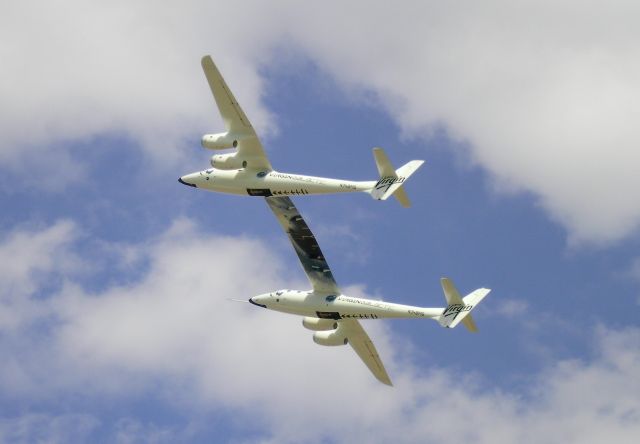 N348MS — - White Knight Two... Flight demo at Oshkosh 2009 after flying from Mohave, California to Oshkosh at 53,000 feet. Other photos clearly show the nose art & logo VMS-EVE... which means Virgin-Mother-Ship EVE.  In this photo, the 140-feet all-composite wing is clearly evident.