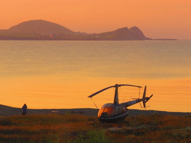 Robinson R-44 (C-GDKE) - Early morning on the beach. This little bird is used for scenic flights over the Magdalen Islands and is parked on the beach of our hotel for the night.