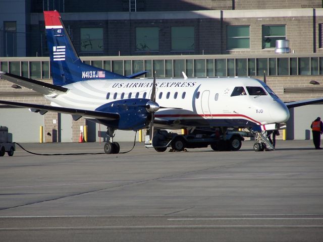 Saab 340 (N413XJ) - Mesaba took over the La Guardia - Providence route from Piedmont on March 28 N413XJ sits on the PVD ramp with the second service of the day in US Airways Express colours