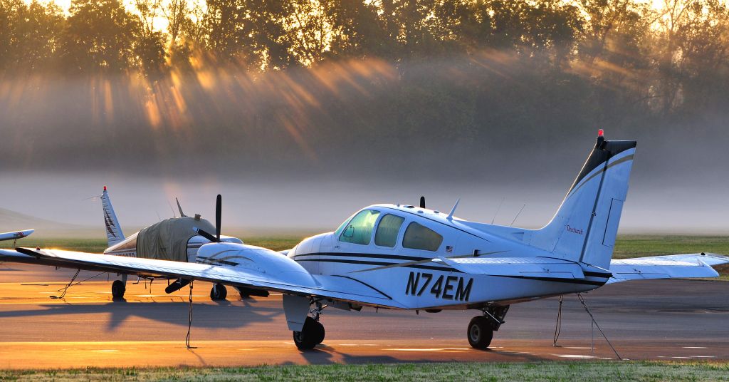 Beechcraft 55 Baron (N74EM) - Early morning fog on the east ramp.