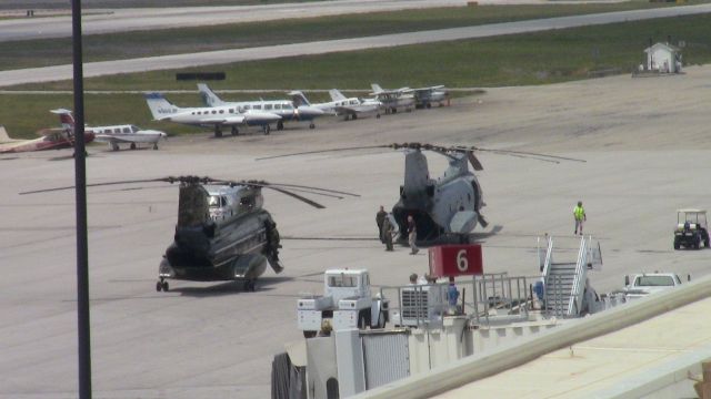 VERTOL 107 (15-7680) - NIGHTHAWK72 flight of 2 sitting on the Lane Aviation ramp. There was a third CH-46 sitting behind the terminal building.