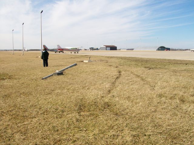 Cessna Commuter (N18040) - This is taken from approximately where 18040 ended up. Originally it was parked next to the Skyhawk on the ramp. It tumbled end over end and landed on its wheels out here in the grass, knocking over the light pole on its way.