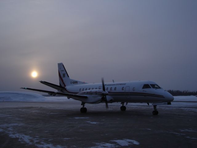 C-GXPS — - Corporate Express Airlines starts up ahead of departure for Calgary International Airport on a frosty December morning. Note how low the sun is on the southern horizon at this latitude (Fort McMurray, Alberta) in the winter!