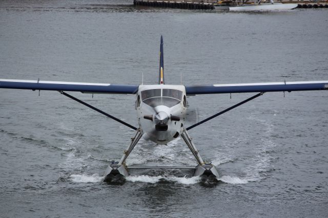 De Havilland Canada DHC-3 Otter (C-FIUZ) - Otter followed the Black Bell Ferry out of the harbor.