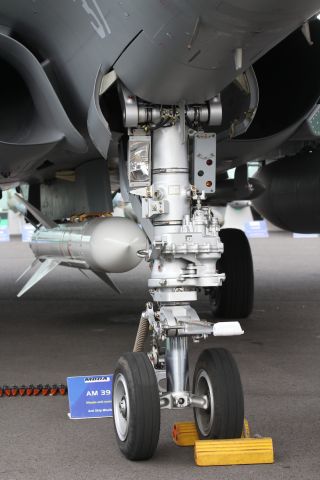 — — - Close up view of a Dassault "Navy" Rafale nose landing gear, featuring the launch catapult hook.