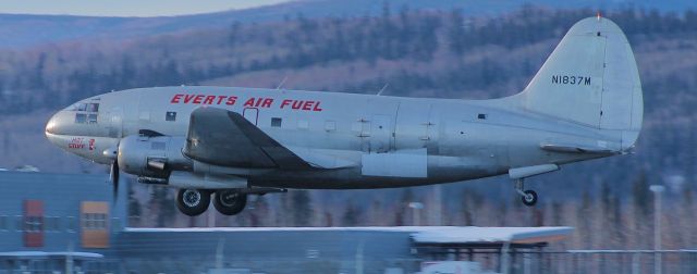 — — - C-46 cleaning up on climbout.