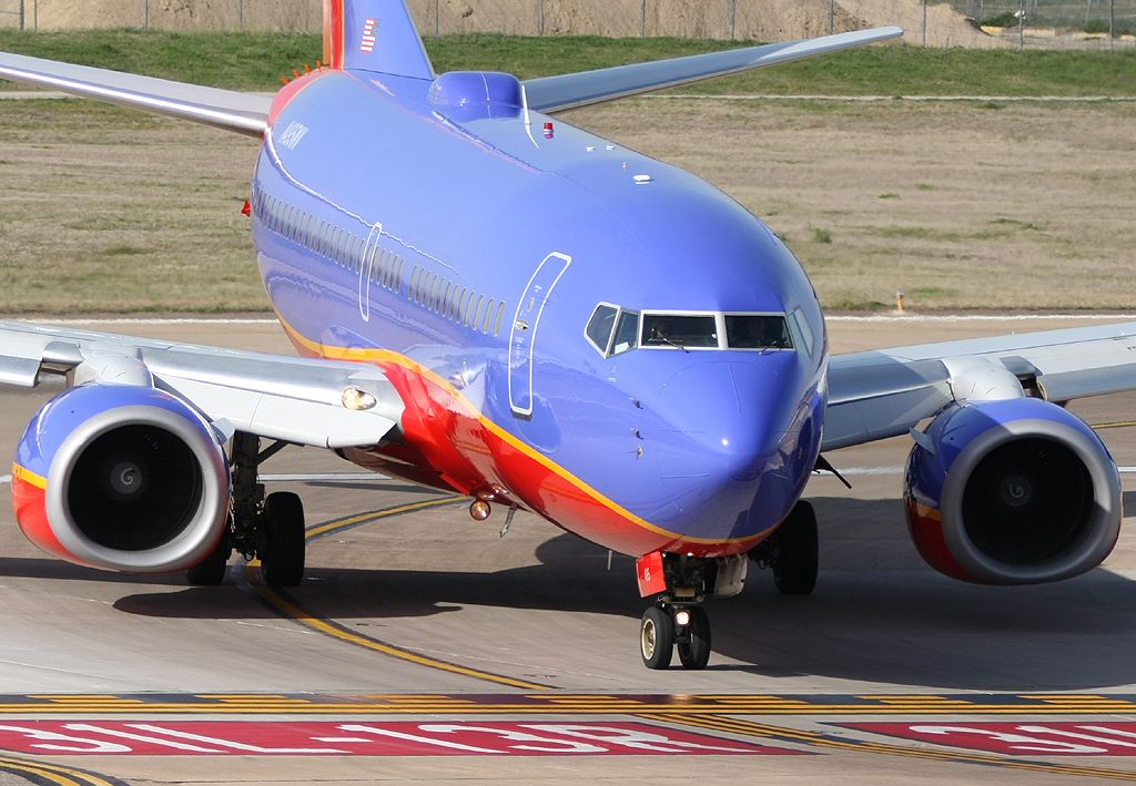 Boeing 737-700 (N495WN) - Exiting 13R.  Imaged from top level of Lot B.