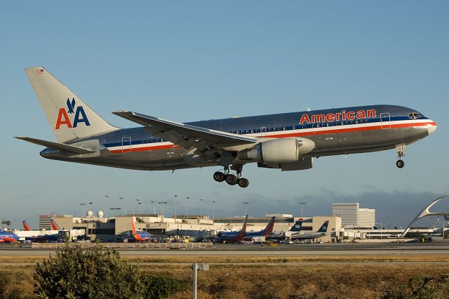 BOEING 767-200 (N325AA) - Photo taken July 8, 2012.  Nikon D-50 br /The late afternoon summer sun makes for good spotting on the north side of LAX.    