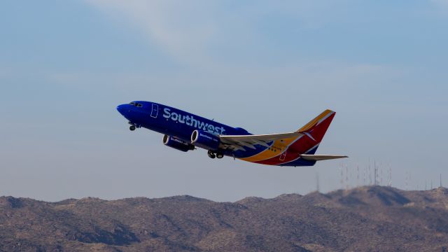 Boeing 737-700 (N963WN) - Southwest Airlines 737-700 taking off from PHX on 9/3/22. Taken with a Canon 850D and Rokinon 135mm f/2 manual focus lens.