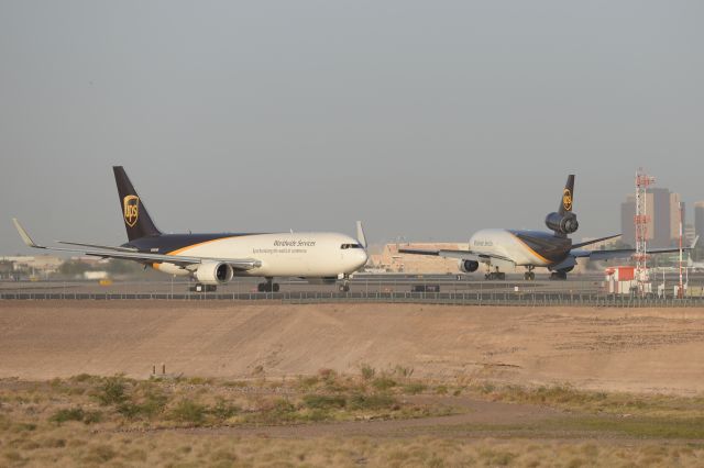 BOEING 767-300 (N350UP) - N350UP is waiting to cross 7L while a UPS MD-11F is landing. 