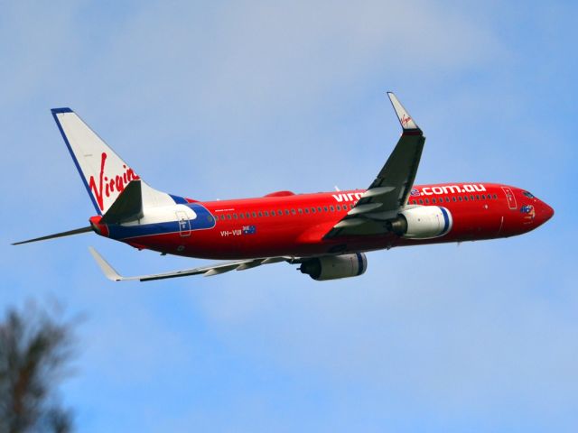 Boeing 737-700 (VH-VUI) - Getting airborne off runway 23 on a gloomy, cold winters day. Wednesday 4th July 2012.