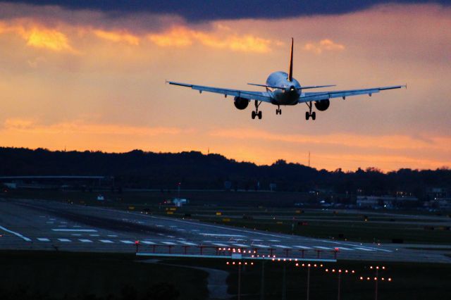 Airbus A319 — - A319 on final during sunset.