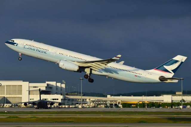 Airbus A330-300 (B-HLF) - CX A333 takes off in the warm evening sun, headed for HKG. In the background is a USAF C-17 Globemaster, here as part of the logistics support for President Obamas visit to Malaysia.