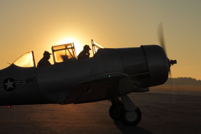 FLY SYNTHESIS Texan — - A Commemorative Air Force T-6 warms up on a foggy morning. I was liking the shot but.... Then they turned on the lights and I knew I had something.