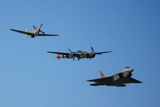 Lockheed P-38 Lightning (N79123) - P-51 "Baby Duck" (N251PW) leading a Heritage Flight formation with an F-22 Raptor and P-38 Lightning "Scat III" (formerly "Ruff Stuff", N79123) concluding the EAA Airventure Warbird Airshow 7/24/2015