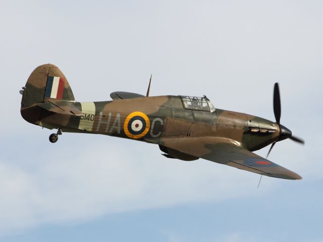 — — - The Hawker Hurricane performs a flypast at Duxford Air Museum. The unsung hero of The Battle of Britain.