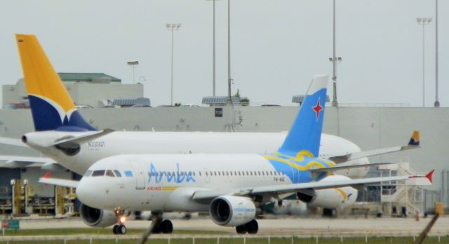 Airbus A319 (P4-AAE) - Size Comparison A Tampa Airlines A330-200F" Reg#A330QT In the background