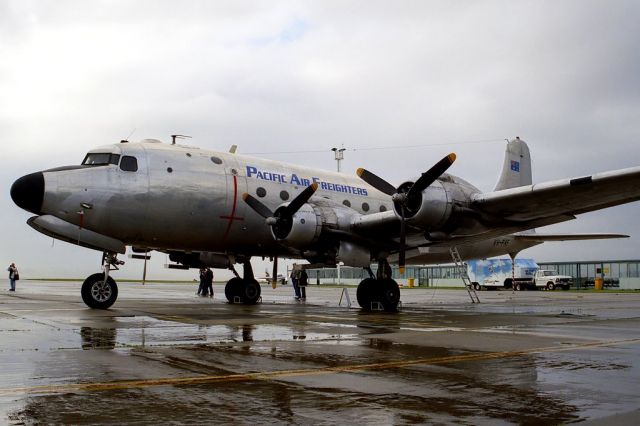 Douglas C-54 Skymaster (VH-PAF) - Phil Vabre photo of the DC-4 at Essendon Victoria on 10 8 1996 - normal day for Melbourne - wet - but makes for nice photos. Now VH-EAY with HARS at Wollongong NSW being restored to fly. Previously N9013V and 44-9126.