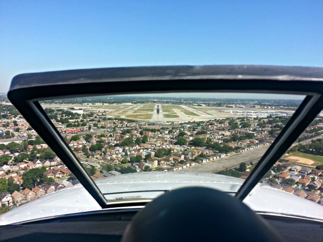 Beechcraft Baron (58) (N524DM) - Short Final, three in the green.