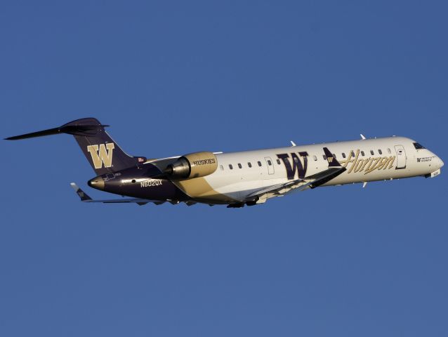 Canadair Regional Jet CRJ-700 (N602QX) - Horizons Washington Huskies CRJ departing Calgary for Seattle.