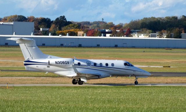 Embraer Phenom 300 (N306GV) - Taxiing for departure is this 2017 Embraer Phenom 300 in the  Autumn of 2019.