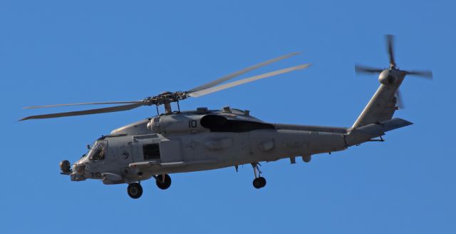 Sikorsky S-70 (16-8150) - An MH-60R Strike Hawk (Seahawk) of the HSM-71 "Raptors" (NAS North Island, San Diego) climbs away toward the sun.