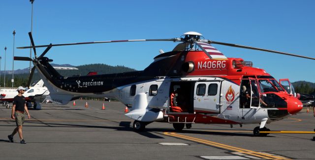 TUSAS Cougar (N406RG) - N406RG, a Eurocopter AS 332L Super Puma "Firecat," is being towed by a team of Precision personnel (*see Note) to a static display position for public viewing at the Truckee Tahoe Air Show and Family Fest event at KTRK yesterday (23 Jul 2022). The event, which is usually held annually but was not held last year due to a fatal crash that occurred at the airport a week or so prior to the scheduled event, is 100% free to attendees (free parking and free admission).br /* Note: N406RG was provided (funded) to Precision by the Coldstream Group. *