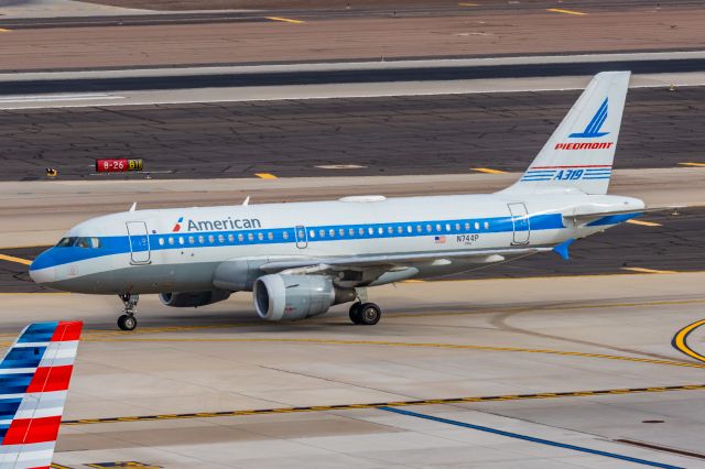 Airbus A319 (N744P) - An American Airlines A319 in Piedmont retro livery taxiing at PHX on 2/13/23, the busiest day in PHX history, during the Super Bowl rush. Taken with a Canon R7 and Canon EF 100-400 II L lens.