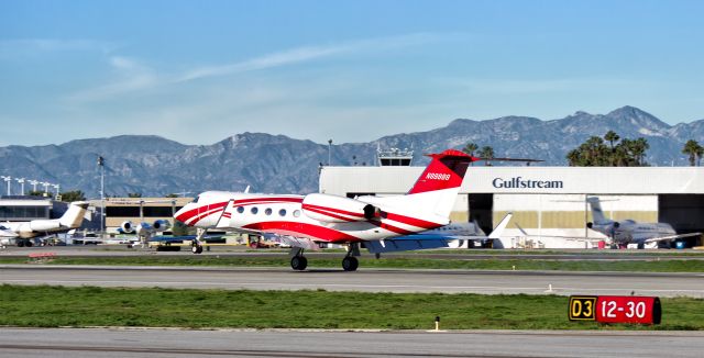 Gulfstream Aerospace Gulfstream IV (N89888) - A beautiful red and white Gulfstream G-IV (N89888) touching down between the Gulfstream facility signs at KLGB